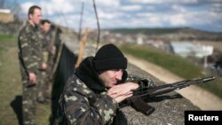 Ukraine - Ukrainian servicemen stand guard at an air base located in the village of Lyubimovka near a local airfield, southwest of Simferopol, Crimea's capital March 5, 2014